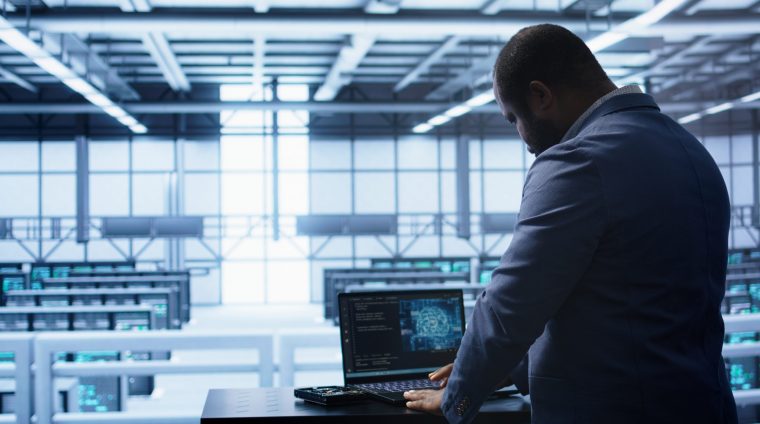 Artificial intelligence technology simulating human brain used by engineer in data center. Worker working on digital device with AI tech machine learning algorithms, camera B