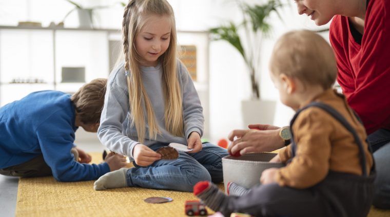 side-view-teacher-watching-kids-playing